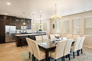 a kitchen and dining room with a table and chairs at Four-Bedroom House in Santa Clara