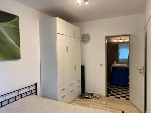 a bedroom with a white refrigerator and a sink at Green House Strassen in Strassen