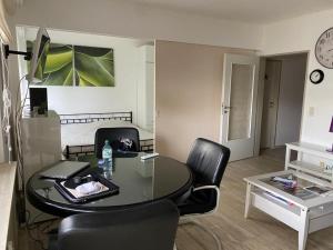 a living room with a table and chairs and a room at Green House Strassen in Strassen +3 photos