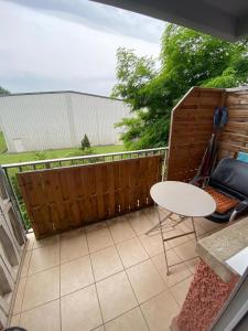 a patio with a white table and a fence at Green House Strassen in Strassen