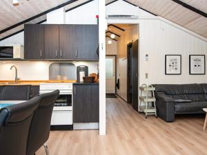 a kitchen and a living room with a couch at 6 person holiday home in Oksbøl-By Traum in Oksbøl +30 photos