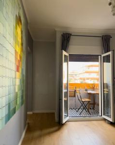 a hallway with a door open to a patio with a table at Homevision - Stylish & Serene Condo - City Center in Thessaloniki +20 photos