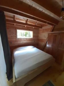 a small room with a bed in a wooden cabin at Casa Aurora in Puerto Fuy +20 photos