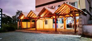 a building with awning in front of a building at Do Parque Pousada in Penha