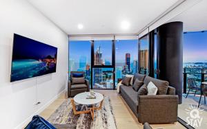 a living room with a couch and a tv at Casino Private Apartments - QStay in Gold Coast