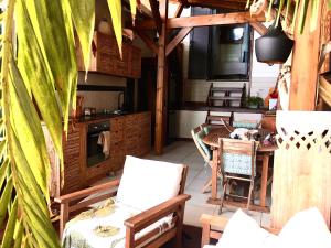a patio with a table and chairs and a kitchen at Kazasoley in Le Gosier