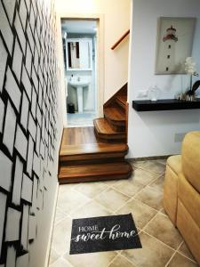 a stairway with a house shaped home sign on the floor at El Viaje a Elba Centro y Playa in Vilagarcia de Arousa