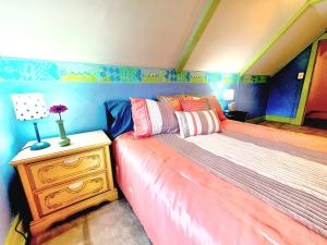 a bedroom with a bed and a table with a lamp at BELLE ON HARLEM - Shared Homestay in Rockford