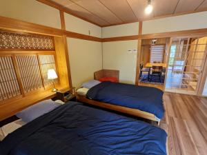 Postel nebo postele na pokoji v ubytování Yuzan apartment Sanjo