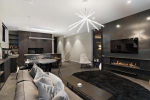 a living room with a couch and a fireplace at The Ivy Box Apartment in Queenstown