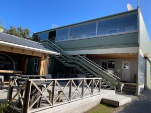 a building with a staircase on the side of it at Te Anau Lakefront Backpackers in Te Anau