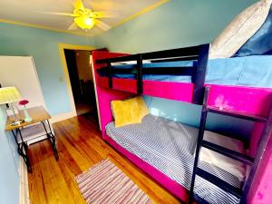 a bedroom with a bunk bed with a ceiling at BELLE ON HARLEM - Shared Homestay in Rockford