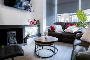 a living room with a couch and a table at Warwick West in Barrow in Furness