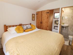 a bedroom with a large bed and a bathroom at Quarry House in Whiston