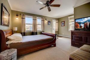 a bedroom with a bed and a flat screen tv at 3 - 4 Bdrm Victorian Beach House in Asbury Park