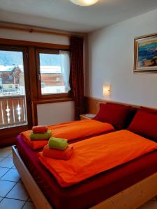 a bedroom with a large bed with towels on it at Chalet Beatrice in Livigno