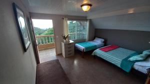 巴拿馬城的住宿－Toucan Place，一间带两张床的小卧室和一个阳台
