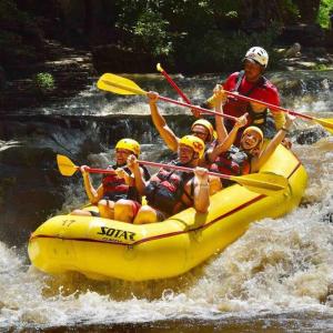 a group of people in a raft on a river at Loft Stronger Spot in Bagaces