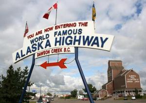 a sign that says new entering the world famous ashka highway at The George Dawson Inn & Conference Centre in Dawson Creek