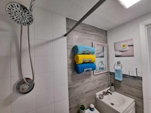a bathroom with a shower and a toilet and a sink at Relax 521- at the side in Miami