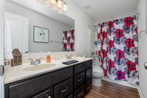 a bathroom with a sink and a shower curtain at 1392 Soaring Way Brand new construction in well-kept HOA community in Maineville