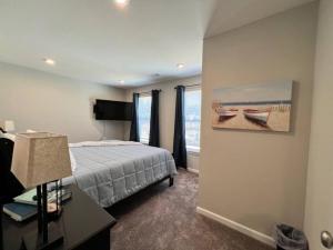 a bedroom with a bed and a painting of boats at 7876 Ellington Court Cheerful 4 Bedroom Home Brand New Construction in Maineville