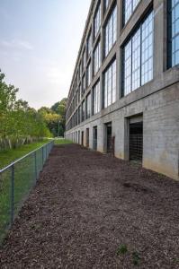 a large building with a fence in front of it at 5103 Peters New Industrial Loft on Lebanon Bike Trail in Maineville