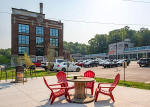 a group of red chairs and a table in a parking lot at 5103 Peters New Industrial Loft on Lebanon Bike Trail in Maineville