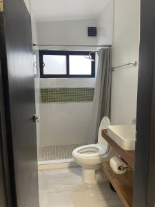 a bathroom with a toilet and a sink at Casa Daniel in Ensenada