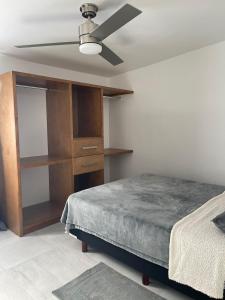 a bedroom with a bed and a ceiling fan at Casa Daniel in Ensenada