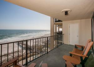 a balcony with two chairs and a view of the beach at Phoenix II 2067 in Orange Beach