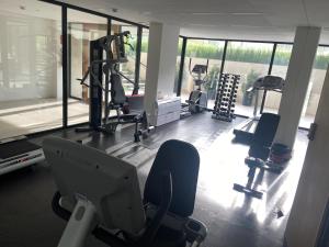 a gym with treadmills and exercise equipment and windows at Exclusivo y elegante! in Montevideo