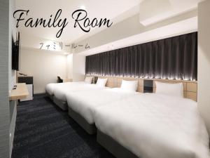 A bed or beds in a room at Henn na Hotel Premier Nagoya Fushimiekimae