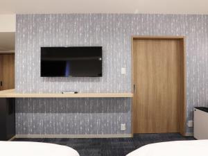 A television and/or entertainment centre at Henn na Hotel Premier Nagoya Fushimiekimae