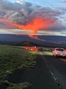 a group of cars driving down a road with a fire explosion at Ocean View Paradise! in Hawaiian Ocean View