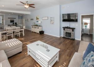 a living room with a couch and a fireplace at Poseidon Palace in Sand Landing