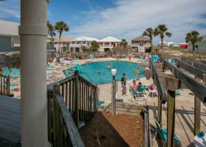 a large swimming pool with people in it at Poseidon Palace in Sand Landing