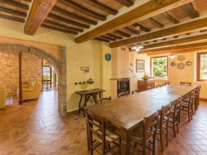 a large dining room with a large wooden table and chairs at Belvilla by OYO Villa Fufi in Arcevia
