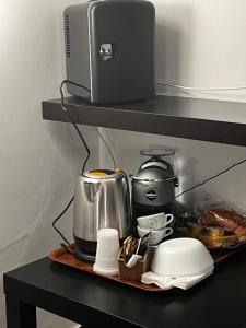 a shelf with a coffee maker and a blender at Beb dell arechi in Salerno