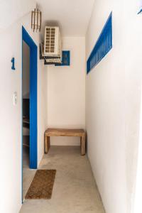 a hallway with a room with a heater and a bench at Villa Hortencia Trancoso in Trancoso