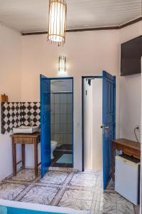 a bathroom with a blue door and a sink at Villa Hortencia Trancoso in Trancoso