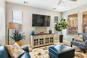 a living room with a tv and a couch and chairs at Zion Poolhouse home in Washington