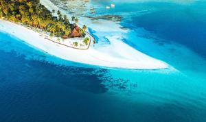 an island in the ocean with a church on it at Koh Mook Sivalai Beach Resort in Ko Mook