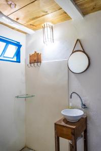 baño con lavabo y espejo en la pared en Villa Hortencia Trancoso en Trancoso