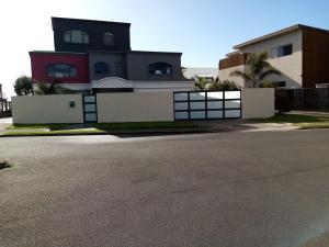 a house with a fence and a driveway at Sunbrae Beach in Mount Maunganui