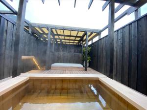 a wooden deck with a massage bench on top at Hotel Zagakukan in Hakone