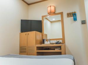 Postel nebo postele na pokoji v ubytování Hotel 81 Sakura