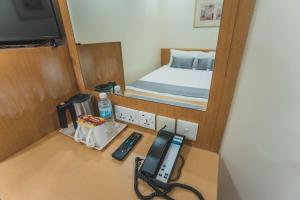 Postel nebo postele na pokoji v ubytování Hotel 81 Sakura