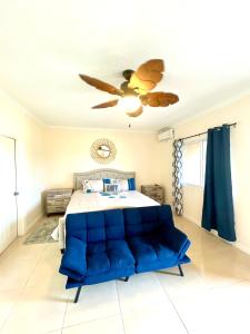 a bedroom with a bed and a ceiling fan at My Palm Retreat in Mammee Bay