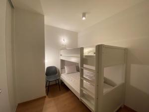 Cette chambre comprend 2 lits superposés et une chaise. dans l'établissement Appartement Châtel, 3 pièces, 6 personnes - FR-1-693-48, à Châtel